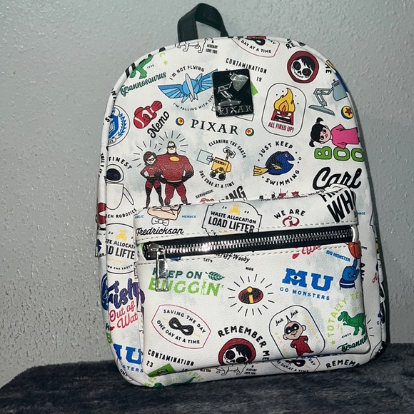 Disney Handbags - BRAND NEW Disney Pixar Icon Toss Print AOP Mini Backpack